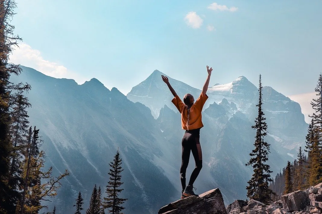 woman hiking in the mountains sunny