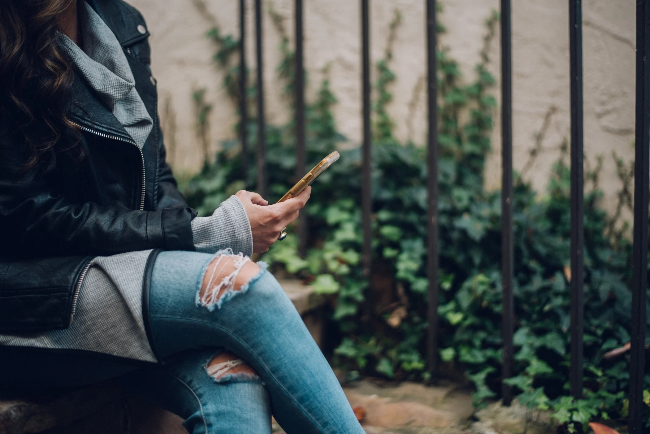 woman checking phone for messages calls and emails